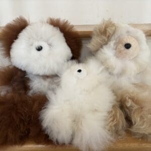 A group of stuffed animals sitting in a row.