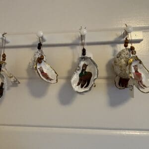 A white wall with several hanging cups on it.