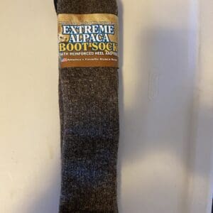 A brown sock that is on the floor