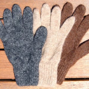 Three pairs of gloves are shown on a wooden surface.