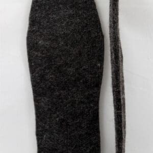 A black tie and a white shirt on top of a table.