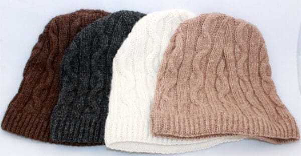 A group of four hats sitting next to each other.