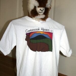 A goat is wearing a t-shirt with the name of a mountain.