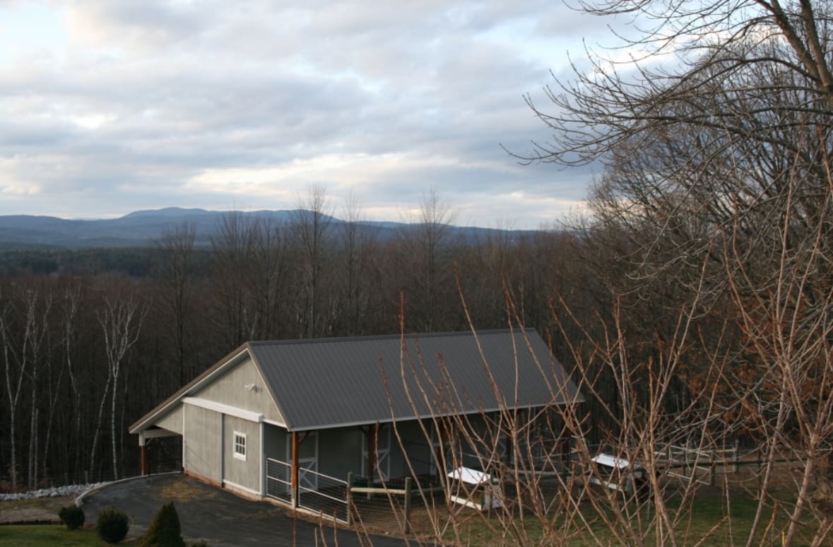 A small white building with trees in the background