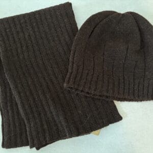 A brown scarf and hat on top of the table.